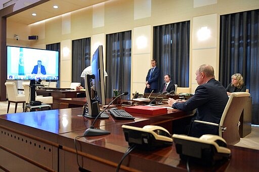 Russian President Vladimir Putin attends a videoconference with G20 leaders to discuss the coronavirus disease outbreak at the Novo-Ogaryovo residence outside Moscow, Russia, Thursday, March 26, 2020. Leaders of the world's most powerful economies will convene virtually to coordinate a response to the fast-spreading new coronavirus. The new coronavirus causes mild or moderate symptoms for most people, but for some, especially older adults and people with existing health problems, it can cause more severe illness or death. (Alexei Druzhinin, Sputnik, Kremlin Pool Photo via AP)