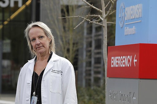 In this Tuesday, March 24, 2020, photo, Dr. Tanya Sorensen, a practicing maternal fetal medicine physician at Swedish Medical Center, and executive director for women's services, poses in Edmonds, Wash., north of Seattle. Several dozen expectant moms who had planned to give birth at the birth unit of the center will now have to go elsewhere because the facility is being repurposed to treat victims of the new coronavirus. (AP Photo/Ted S. Warren)