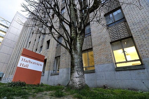 In this photo taken March 24, 2020, Harborview Hall is shown on the grounds of Harborview Medical Center in Seattle. A homeless shelter run by the Salvation Army will be temporarily moved from the building to another location so that the facility can house patients recovering from the new coronavirus. (AP Photo/Ted S. Warren)