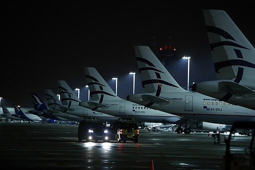 Aircraft of Aegean Airlines are parked at Eleftherios Venizelos International Airport in Athens, Thursday, March 26, 2020. The Greek airline carrier announced that they will suspend all international flights from March 26 until April 30, because of the coronavirus outbreak and the travel restrictions imposed by the Greek government, the EU and other states. (AP Photo/Thanassis Stavrakis)