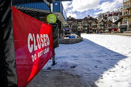 This Tuesday, March 24, 2020, photo shows a closed ski lift in Vail, Colo., after Vail Ski Resort closed for the season amid the COVID-19 pandemic. Ski resorts across the West that were shut down amid coronavirus fears are grappling with an economic &#147;body blow&quot; at a time when they normally would be welcoming hoards of spring break revelers.  (AP Photo/Michael Ciaglo)