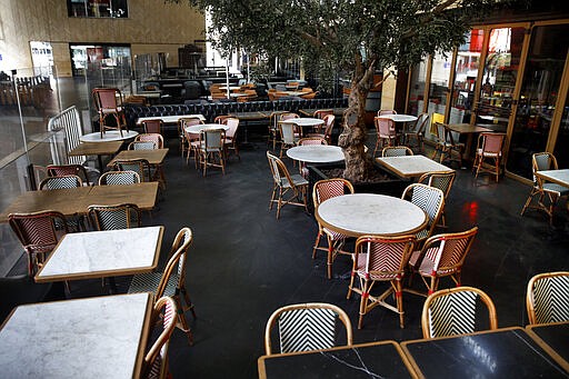 This Monday, March 16, 2020 photo, shows a closed restaurant after authorities ordered the closure, as part of the preventive measures against the coronavirus, in Beirut, Lebanon. The COVID-19 pandemic has managed to do what various wars could not: Close bars, restaurants and entertainment spots across the tiny Mediterranean country. (AP Photo/Bilal Hussein)