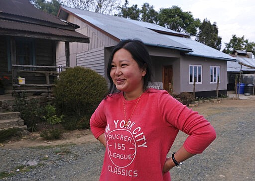 In this Sunday, March 22, 2020, photo, Ringhuila Zimik, 26, smiles as she speaks about the rumor of medicine being sprayed from the sky to contain a new virus, in Shangshak village, in the northeastern Indian state of Manipur. &quot;We all heard about it. I didn't know whether to believe it or not but stayed indoors anyway,&quot; she said. As India and other South Asian nations brace for the likely spread of the virus, they are facing another battle: reams of misinformation, misleading rumors and false claims. This battle has been hard to contain as social media continues to be rife with bogus remedies to tales of magic cure and potentially dangerous medical advice. (AP Photo/Yirmiyan Arthur)