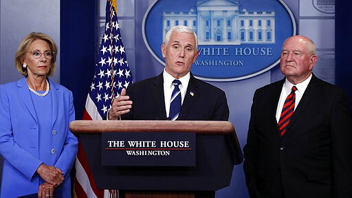 Vice President Mike Pence speaks about the coronavirus in the James Brady Press Briefing Room, Friday, March 27, 2020, in Washington, as Education Secretary Betsy DeVos and Agriculture Secretary Sonny Perdue listen. (AP Photo/Alex Brandon)