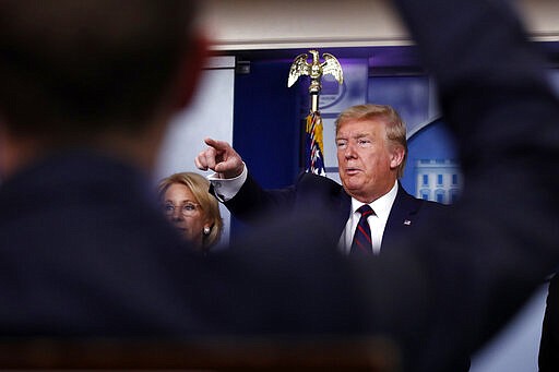 President Donald Trump takes questions from reporters as he speaks about the coronavirus in the James Brady Press Briefing Room, Friday, March 27, 2020, in Washington. (AP Photo/Alex Brandon)