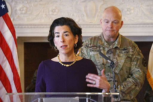 Rhode Island Governor Gina Raimondo addresses the media during a press at the State House in Providence. At rear right is Behind the Governor is Col. Christopher P. Callahan of the Rhode Island National Guard. (Sandor Bodo/Providence Journal via AP, Pool)