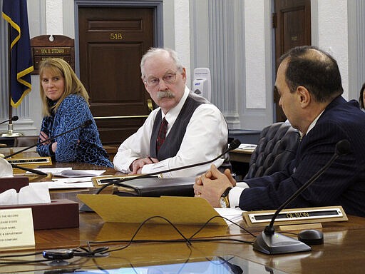 Alaska state Sen. Donny Olson, right, speaks as Senate Finance Committee Co-chairs Natasha von Imhof and Bert Stedman, center, listen during a conference committee meeting on Friday, March 27, 2020, in Juneau, Alaska. A conference committee of House and Senate negotiators was tasked with hammering out differences on a state spending package. (AP Photo/Becky Bohrer)