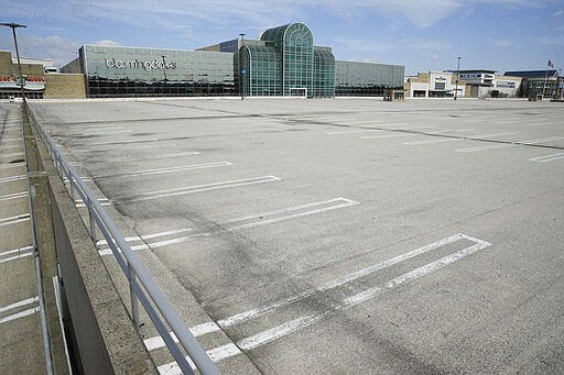 The parking lot is empty for the King of Prussia Mall which is closed to the public due to the ongoing coronavirus pandemic, in King of Prussia, Pa., Friday, March 27, 2020. (AP Photo/Matt Rourke)