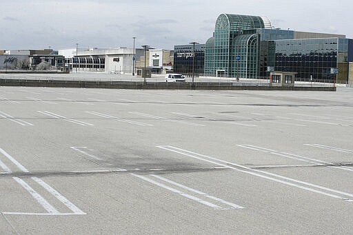 The parking lot is empty for the King of Prussia Mall which is closed to the public due to the ongoing coronavirus pandemic, in King of Prussia, Pa., Friday, March 27, 2020. (AP Photo/Matt Rourke)