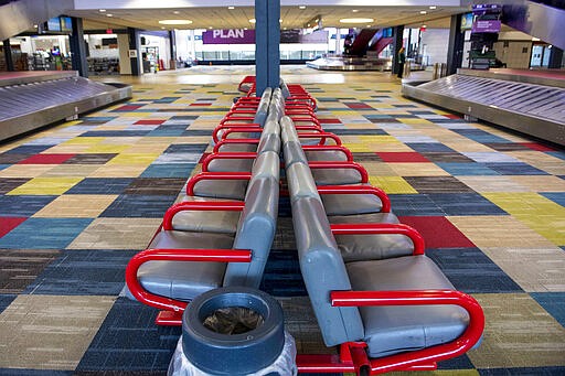 In this Tuesday, March 24, 2020 photo, the baggage claim area is empty at the Pittsburgh International Airport in Moon, Pa. (Emily Matthews/Pittsburgh Post-Gazette via AP)