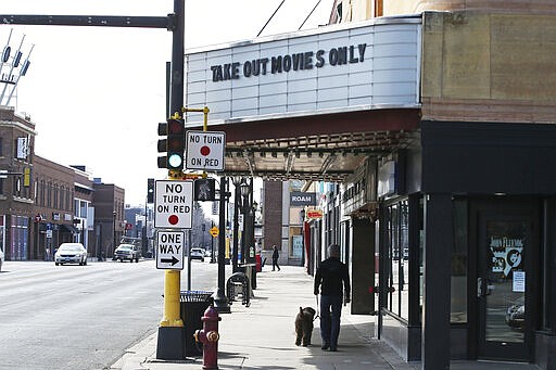 The marquee at the Uptown Theater spoofs restaurant take-out-only language with this sign Friday, March 27, 2020, in Minneapolis. Minnesota Gov. Tim Walz issued a stay-at-home order effective at midnight Friday to help stop the spread of the coronavirus in the state. Outdoor activities such as walking are permitted. The new coronavirus causes mild or moderate symptoms for most people, but for some, especially older adults and people with existing health problems, it can cause more severe illness or death. (AP Photo/Jim Mone)