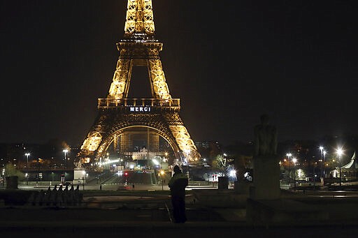 The word &quot;Merci&quot;, the French word for 'Thank you&quot;, is emblazoned on the Eiffel Tower as France's coronavirus death toll continued to climb, in Paris, Friday, March 27, 2020. Health workers fighting to save lives in France from COVID-19 have received a huge show of gratitude, from the Eiffel Tower. The new coronavirus causes mild or moderate symptoms for most people, but for some, especially older adults and people with existing health problems, it can cause more severe illness or death. (AP Photo/Thibault Camus)