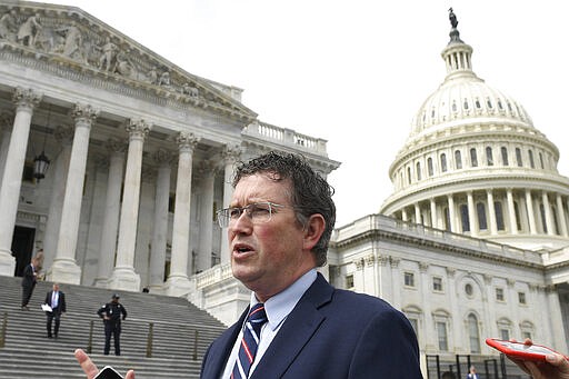 Rep. Thomas Massie, R-Ky., leaves Capitol Hill in Washington, Friday, March 27, 2020, after attempting to slow action on a rescue package. Despite Massie's effort and acting with exceptional resolve in an extraordinary time, the House rushed President Donald Trump a $2.2 trillion rescue package, tossing a life preserver to a U.S. economy and health care system left flailing by the coronavirus pandemic. (AP Photo/Susan Walsh)