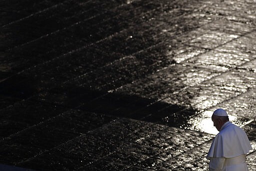 Pope Francis walks during Urbi and Orbi prayer (Latin for To the City and To the World) in an empty St. Peter's Square, at the Vatican, Friday, March 27, 2020. Praying in a desolately empty St. Peter's Square, Pope Francis on Friday likened the coronavirus pandemic to a storm laying bare illusions that people can be self-sufficient and instead finds &#147;all of us fragile and disoriented&#148; and needing each other's help and comfort. The new coronavirus causes mild or moderate symptoms for most people, but for some, especially older adults and people with existing health problems, it can cause more severe illness or death. (Yara Nardi/Pool Photo via AP)