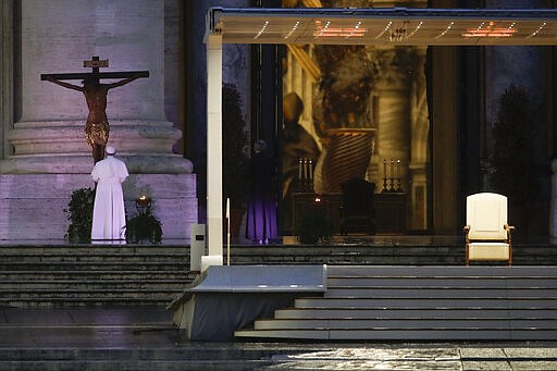 Pope Francis, left, prays in front of a miraculous crucifix that in 1552 was carried in a procession around Rome to stop the great plague, during Urbi and Orbi prayer (Latin for To the City and To the World) from an empty St. Peter's Square, at the Vatican, Friday, March 27, 2020. Praying in a desolately empty St. Peter's Square, Pope Francis on Friday likened the coronavirus pandemic to a storm laying bare illusions that people can be self-sufficient and instead finds &quot;all of us fragile and disoriented&quot; and needing each other's help and comfort. The new coronavirus causes mild or moderate symptoms for most people, but for some, especially older adults and people with existing health problems, it can cause more severe illness or death. (AP Photo/Alessandra Tarantino)