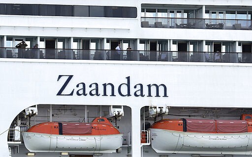 The Zaandam cruise ship, carrying some guests with flu-like symptoms, is anchored after it arrived to the bay of Panama City, Friday, March 27, 2020, amid the worldwide spread of the new coronavirus. Health authorities are expected to board the ship to test passengers and decide whether it can cross the Panama Canal. (AP Photo/Arnulfo Franco)