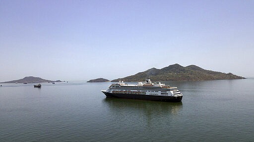 The Zaandam cruise ship, carrying some guests with flu-like symptoms, is anchored shortly after it arrived to the bay of Panama City, Friday, March 27, 2020, amid the worldwide spread of the new coronavirus. Health authorities are expected to board the ship to test passengers and decide whether it can cross the Panama Canal. (AP Photo/Arnulfo Franco)