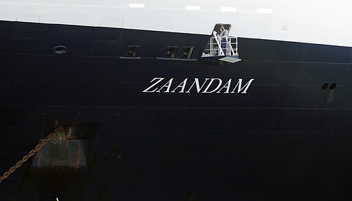 The Zaandam cruise ship, carrying some guests with flu-like symptoms, is anchored after it arrived to the bay of Panama City, Friday, March 27, 2020, amid the worldwide spread of the new coronavirus. Health authorities are expected to board the ship to test passengers and decide whether it can cross the Panama Canal. (AP Photo/Arnulfo Franco)