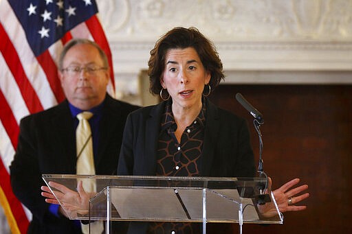 FILE - In this Sunday, March 22, 2020 file photo, Gov. Gina Raimondo gives an update on the coronavirus during a news conference in the State Room of the Rhode Island State House in Providence, R.I. Amid the continuing COVID-19 coronavirus outbreak, Raimondo is warning that the virus&#146; widening economic fallout could lead to government layoffs in a state that already was facing a $200 million shortfall. Rhode Island lawmakers also approved borrowing up to $300 million to help the state cover its bills. (Kris Craig/Providence Journal via AP, Pool)