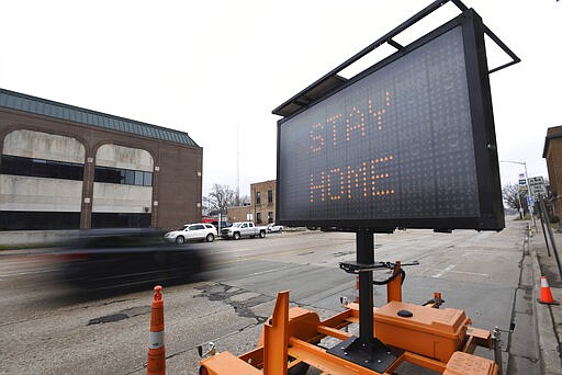 A sign encourages the public to stay at home and stay safe during the coronavirus outbreak Friday, March 27, 2020, in downtown St. Joseph, Mich. Officials declared a state of emergency for Berrien County on Thursday due to the COVID-19 pandemic.(Don Campbell/The Herald-Palladium via AP)