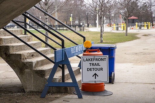 Chicago police block access to the Lake Shore Drive pedestrian bridge leading to the Lakefront Trail at North Avenue Beach as the city closes the area to pedestrians amid fears of the coronavirus pandemic, Thursday morning, March 26, 2020. (Ashlee Rezin Garcia/Chicago Sun-Times via AP)