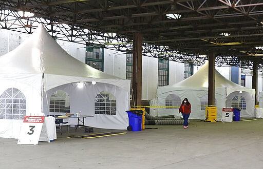 Examination tents are setup at the Michigan State Fairgrounds, Friday, March 27, 2020, in Detroit, where the city is preparing for coronavirus drive up testing. (AP Photo/Carlos Osorio)