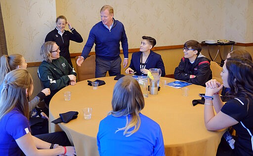 FILE - In this Feb. 26, 2019, file photo, NFL Commissioner Roger Goodell greets Saskatchewan equipment manager/team administrator Andrea Eccleston and other participants, including Bear Lake High School offensive coordinator Sam Mullet, right wearing glasses, at the NFL Women's Forum held in Indianapolis. According to 2019 research by the Institute for Diversity and Ethics in Sport, there are 73 female vice presidents throughout the league. The NFL&#146;s COO is Maryann Turcke. One-third of the working force in NFL offices is made up of women. (AP Photo/AJ Mast, File)