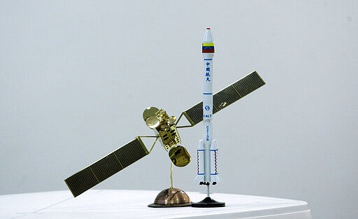 FILE - This Oct. 28, 2008 file photo shows prototypes of a satellite developed by China for Venezuela and a launching rocket on display at a satellite center station in El Sombrero, Venezuela. Venezuela&#146;s only telecommunications satellite has veered off its orbit and stopped working, according to a government statement on March 26, 2020. (AP Photo/Howard Yanes, File)