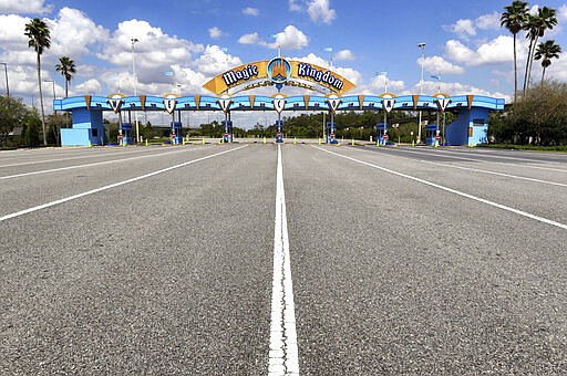 All is quiet at the parking plaza entrance to the Magic Kingdom as Walt Disney World enters its second week of being shut down in response to the coronavirus pandemic,Tuesday, March 24, 2020. (Joe Burbank/Orlando Sentinel via AP)