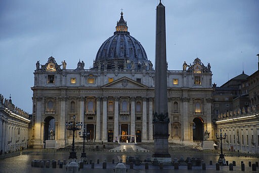 Pope Francis, white figure standing alone at center, delivers an Urbi et orbi prayer from the empty St. Peter's Square, at the Vatican, Friday, March 27, 2020. Because of the COVID-19 pandemic, the Vatican on Friday announced that Francis will celebrate Mass for Palm Sunday, on April 5, Holy Thursday, on April 9 and Easter vigil and Easter Sunday on the weekend of April 11-12, all at the basilica's central altar. The new coronavirus causes mild or moderate symptoms for most people, but for some, especially older adults and people with existing health problems, it can cause more severe illness or death. (AP Photo/Alessandra Tarantino)