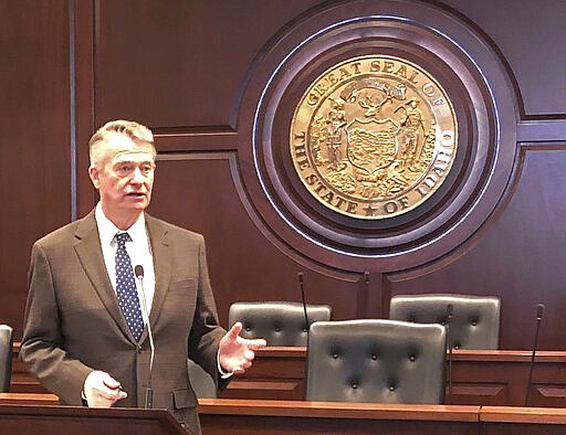 Idaho Gov. Brad Little responds to a reporter's question at the Statehouse in Boise, Idaho on Friday, March 27. Little has ordered a 1% cut in state agency spending because of the economic downturn caused by the coronavirus. The Republican governor said the 1% cutback doesn't apply to healthcare workers. He also on Friday directed the Idaho Department of Labor to make it easier for people who've lost their jobs to file unemployment claims. He also ordered a $40 million transfer of funds to fight the virus. (AP Photo/Keith Ridler)