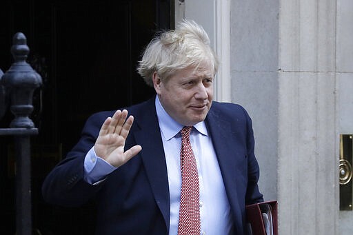 FILE - In this Wednesday, March 25, 2020 file photo Britain's Prime Minister Boris Johnson leaves 10 Downing Street for the House of Commons for his weekly Prime Ministers Questions, in London. British Prime Minister Boris Johnson has tested positive for the new coronavirus. Johnson's office said Friday March 27, 2020 that he was tested after showing mild symptoms, Downing St. says Johnson is self-isolating and continuing to lead the country's response to COVID-19. (AP Photo/Matt Dunham, File)