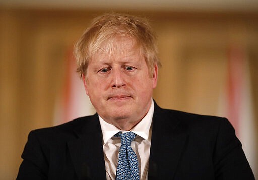 FILE - In this Tuesday, March 17, 2020 file photo British Prime Minister Boris Johnson gives a press conference about the ongoing situation with the COVID-19 coronavirus outbreak inside 10 Downing Street in London. British Prime Minister Boris Johnson has tested positive for the new coronavirus. Johnson's office said Friday March 27, 2020 that he was tested after showing mild symptoms, Downing St. says Johnson is self-isolating and continuing to lead the country's response to COVID-19. (AP Photo/Matt Dunham, Pool)