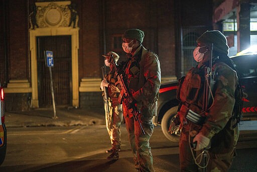 South African Defense Forces patrol downtown Johannesburg, South Africa, Friday, March 27, 2020. Police and army started patrolling moments after South Africa went into a nationwide lockdown for 21 days in an effort to mitigate the spread to the coronavirus. The new coronavirus causes mild or moderate symptoms for most people, but for some, especially older adults and people with existing health problems, it can cause more severe illness or death.(AP Photo/Jerome Delay)