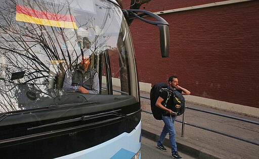 Stranded German tourists get ready to go to the airport in Kathmandu, Nepal, Friday, March 27, 2020. A rescue flight arranged by the German government on Friday picked up tourists who had been stranded in Nepal since the Himalayan nation went on lockdown earlier this week, officials said. Up to 10,000 tourists are believed to be stranded in Nepal since the government ordered a complete lockdown that halted all flights and road travel to prevent the spread of the virus. (AP Photo/Niranjan Shrestha)