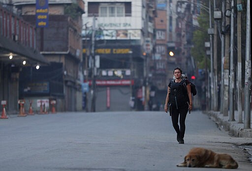 A stranded German tourist arrives to catch a bus to travel to the airport in Kathmandu, Nepal, Friday, March 27, 2020. A rescue flight arranged by the German government on Friday picked up tourists who had been stranded in Nepal since the Himalayan nation went on lockdown earlier this week, officials said. The airport reopened only for the flight, which did not bring any passengers to Nepal. Up to 10,000 tourists are believed to be stranded in Nepal since the government ordered a complete lockdown that halted all flights and road travel to prevent the spread of the virus. (AP Photo/Niranjan Shrestha)