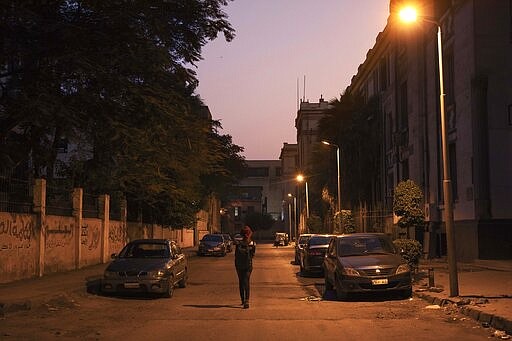 In this Oct. 31, 2019 photo, activist and transgender woman Malak el-Kashif walks in downtown Cairo, Egypt. Shortly before her birthday last year, el-Kashif posted a picture of herself online writing that she had completed her gender transitioning surgeries. &quot;Today is the day I defeated society,&quot; she wrote. &quot;From this day on, there's only Malak.&quot; (AP Photo/Nariman El-Mofty)