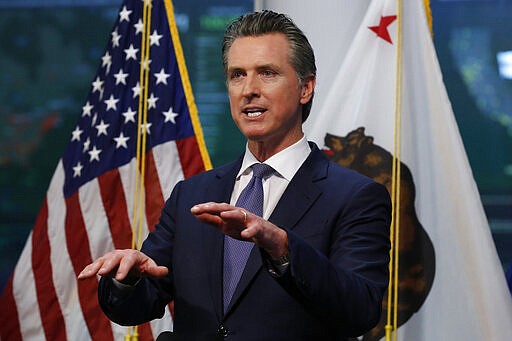 FILE - In this Monday, March 23, 2020 file photo, Gov. Gavin Newsom updates the state's response to the coronavirus at the Governor's Office of Emergency Services in Rancho Cordova, Calif. California has a $20 billion reserve but also relies heavily on capital gains, which swell the state budget when the stock market is soaring. In late March, he warned agency heads that a drop in economic activity would put their ambitions for new or expanded programs on hold. (AP Photo/Rich Pedroncelli, Pool)