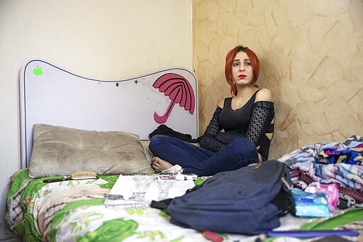 In this Oct. 31, 2019 photo, Egyptian activist and transgender woman Malak el-Kashif sits in her room in Cairo, Egypt. El-Kashif's activism extends beyond advocating for the LGBTQ community. She was arrested last year after she called for protests following a fatal train crash because of what she saw as government negligence. She was imprisoned in a men's prison. The arrest, her third, sparked an outcry as activists and rights groups feared for her safety, especially due to her gender identity. She was held in solitary confinement. (AP Photo/Nariman El-Mofty)