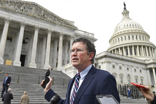 Rep. Thomas Massie, R-Ky., leaves Capitol Hill in Washington, Friday, March 27, 2020, after attempting to slow action on a rescue package. Despite Massie's effort and acting with exceptional resolve in an extraordinary time, the House rushed President Donald Trump a $2.2 trillion rescue package, tossing a life preserver to a U.S. economy and health care system left flailing by the coronavirus pandemic. (AP Photo/Susan Walsh)