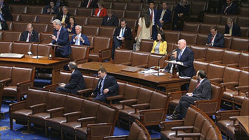 In this image from video, Rep. Kevin McCarthy, R-Texas, left, and Rep. Kevin Brady, R-Texas, stand as they speak on the floor of the House of Representatives at the U.S. Capitol in Washington, Friday, March 27, 2020. (House Television via AP)