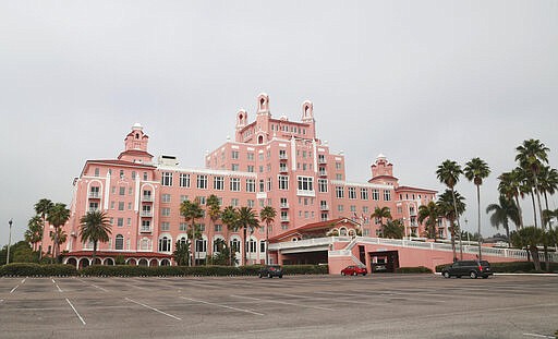 The Don CeSar Hotel, in St. Pete Beach, Fla., has few cars in its parking lot Friday, March 27, 2020, due to the coronavirus pandemic. (Scott Keeler/Tampa Bay Times via AP)