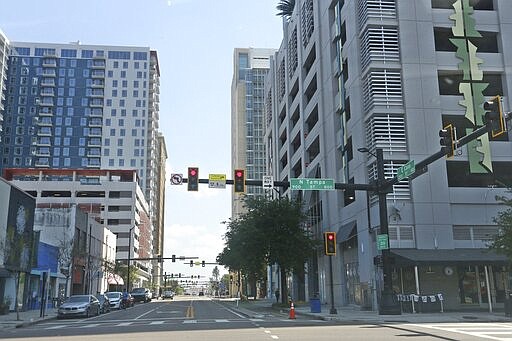 Vehicle traffic in downtown Tampa, Fla., is light late Friday morning, March 27, 2020, due to the coronavirus pandemic. People are staying home. (Scott Keeler/Tampa Bay Times via AP)