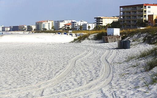 Few visitors are in Madeira Beach, Fla., Friday, March 27, 2020, due to the coronavirus pandemic. (Scott Keeler/Tampa Bay Times via AP)