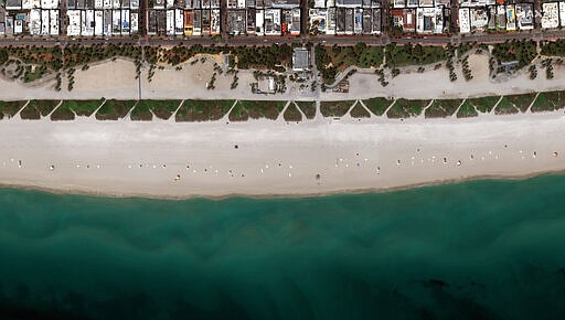 This Friday, March 27, 2020, satellite image provided by Maxar Technologies shows an empty area in Miami Beach, Fla. amid an outbreak of the new coronavirus. The new coronavirus causes mild or moderate symptoms for most people, but for some, especially older adults and people with existing health problems, it can cause more severe illness or death. (Satellite image &Copy;2020 Maxar Technologies via AP)