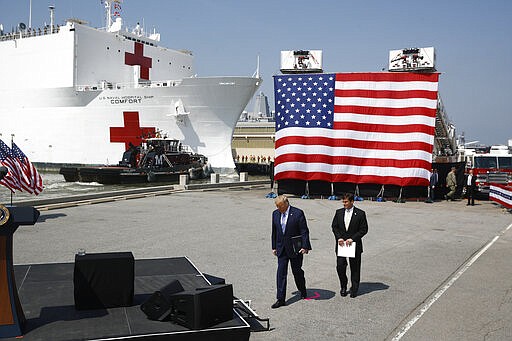 President Donald Trump and Defense Secretary Mark Esper arrive to speak in front of the U.S. Navy hospital ship USNS Comfort at Naval Station Norfolk in Norfolk, Va., Saturday, March 28, 2020. The ship is departing for New York to assist hospitals responding to the coronavirus outbreak. (AP Photo/Patrick Semansky)