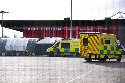 Ambulances and camp tents are seen outside the Excel in London, Saturday, March 28, 2020.The British Government announced Tuesday, that the ExCel Center in east London will become a 4,000 bed temporary hospital to deal with future coronavirus patients, to be called NHS Nightingale. The new coronavirus causes mild or moderate symptoms for most people, but for some, especially older adults and people with existing health problems, it can cause more severe illness or death.(AP Photo/Alberto Pezzali)