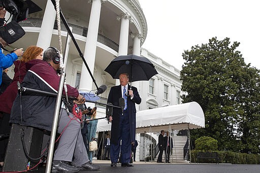 President Donald Trump speaks about the coronavirus as he walks to Marine One to depart the White House, Saturday, March 28, 2020, in Washington. Trump is en route to Norfolk, Va., for the sailing of the USNS Comfort, which is headed to New York. (AP Photo/Alex Brandon)