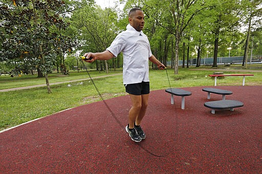 Tommy Laster, 48, uses a boxer's cadence as he skips rope following an afternoon run, Monday, March 23, 2020, in Jackson, Miss. Runners across the country are still hitting the pavement and the trails, staying fit and working off some stress amid the coronavirus pandemic.  (AP Photo/Rogelio V. Solis)