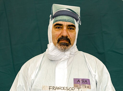 Francesco Tarantini, 54, a nurse at the emergency structures that were set up to ease procedures for the arrival of Covid-19 patients, poses for a portrait at the Brescia Spedali Civili Hospital, in Brescia, Italy Friday, March 27, 2020. (AP Photo/Luca Bruno)